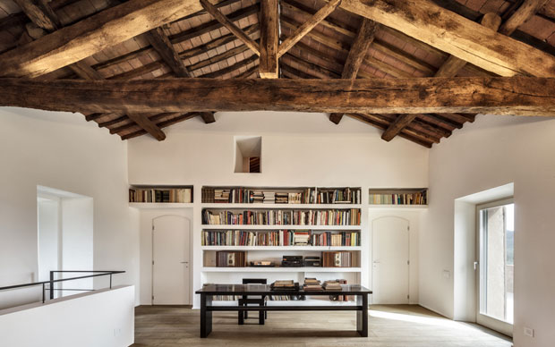 Uno degli studi con la libreria a muro e le travi del soffitto originale a vista