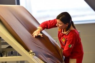 An employee cheks leather pieces in the upholstery department of the Ferrari factory on December 5, 2012 in Maranello. The Ferrari 45 buildings's factory, where more than 3,000 workers produce the company’s GT and Formula 1 cars is based in Maranello. AFP PHOTO / GABRIEL BOUYS        (Photo credit should read GABRIEL BOUYS/AFP via Getty Images)